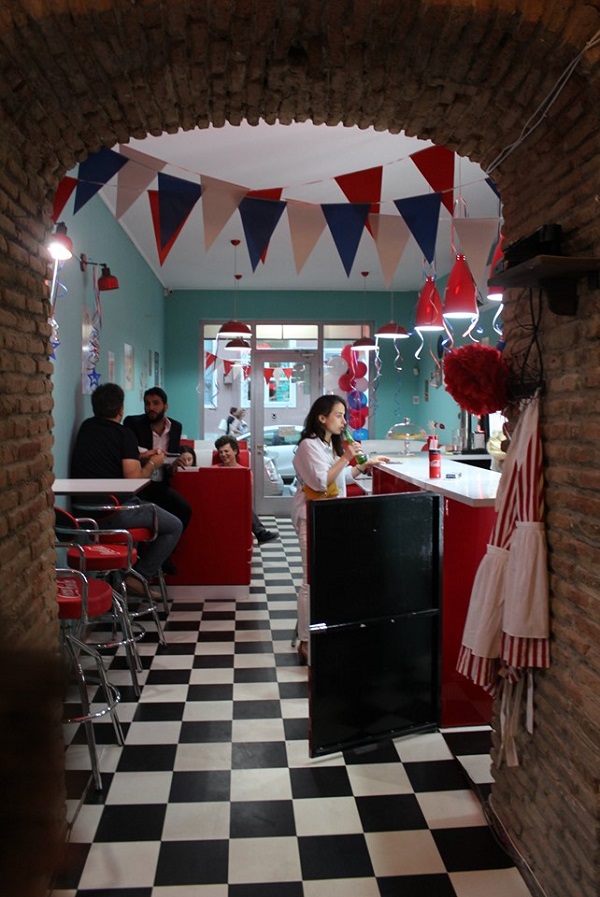 Visitors in venue using space styled around jukebox concept